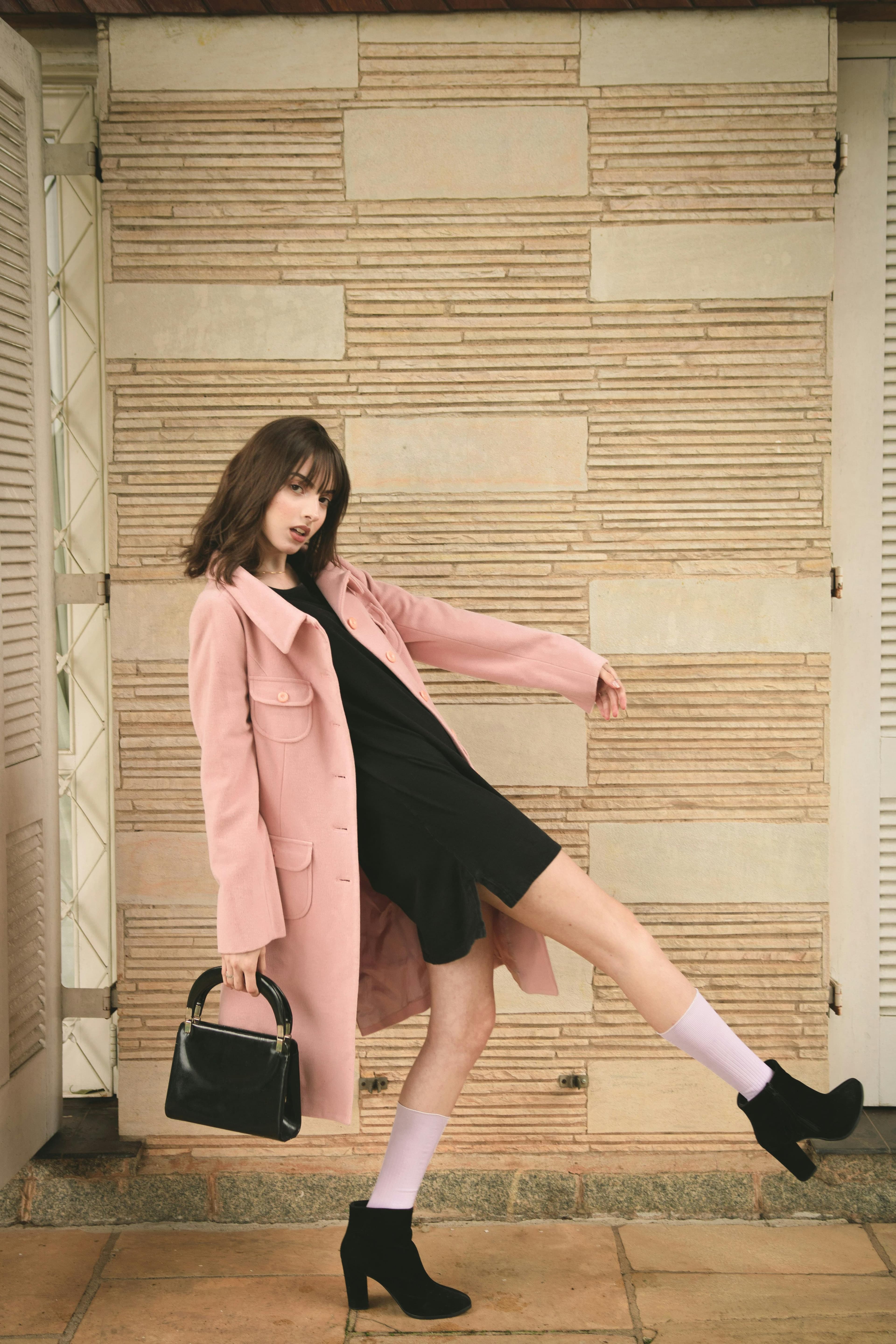 Model wearing pink blazer and black dress